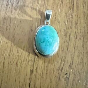 Larimar 925 pendant on 925 Sterling chain. Chain is 18” long and pendant is 1”.